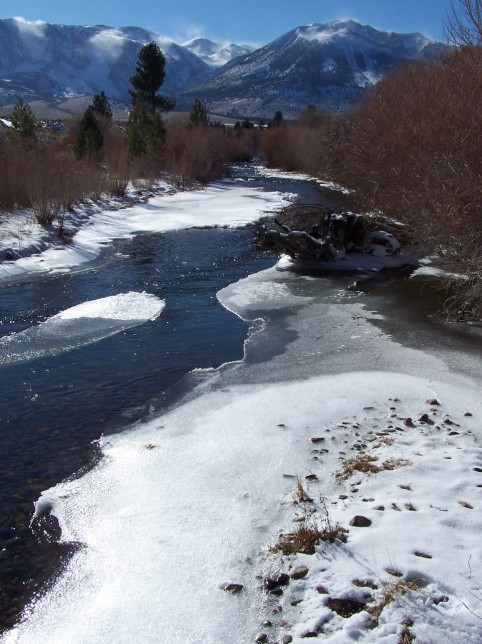 Snow banners blow off the peaks high above icy Rush Creek. Photo by Greg Reis. Snow banners blow off the peaks high above icy Rush Creek. Photo by Greg Reis.
