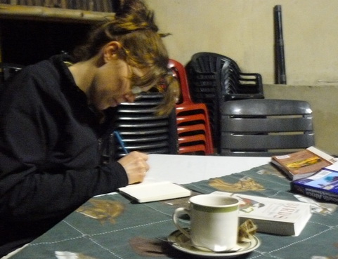 Working on my Mono-logue post in a Zulu hut near the southern tip of St. Lucia. With rooibos tea and the bird book. Photo courtesy of Roger de Freitas.