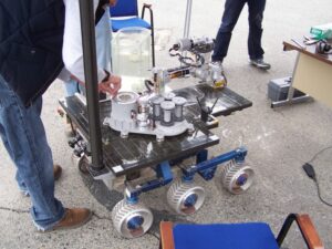 The samples are housed in the container on top of the solar panel. When assembled, this container attaches to the underside of the vehicle. Photo by Greg Reis.