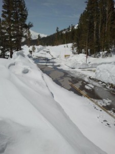 New snow drifts cover the road past the Tioga Pass entrance gates.