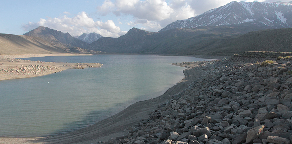 Grant Lake Reservoir’s low level will cause relatively warm and sometimes-turbid water to be released to Rush Creek this summer, negatively impacting the still-recovering trout fishery. Photo by Arya Degenhardt.