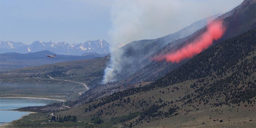 A DC-10 bomber drops fire retardant along the north flank of the Marina Fire on Saturday, June 25. Photo by Bartshe Miller.