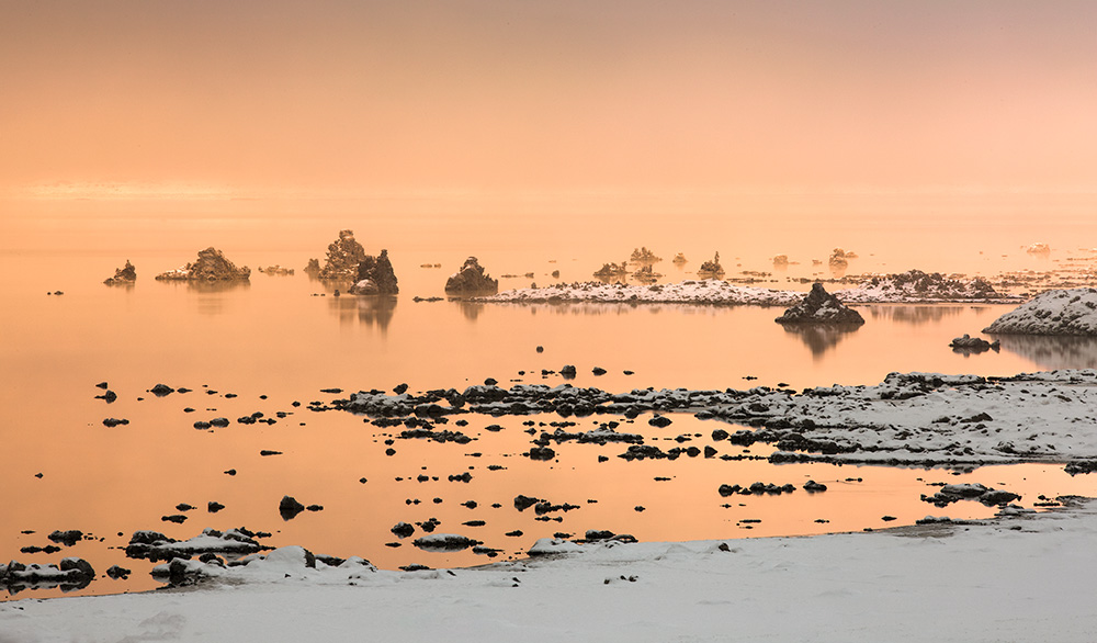 Early morning light sifts through bands of poconip ice fog at Mono Lake. Photo courtesy of Joe Decker.