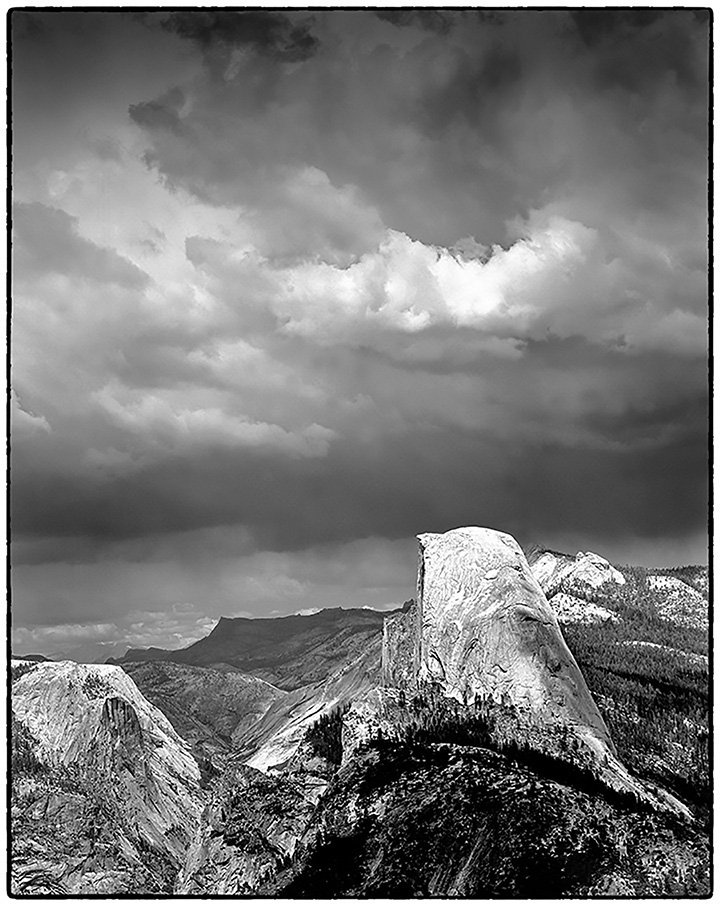 Granite domes and roiling clouds in the sky.