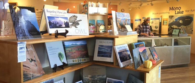 The Mono Lake Committe bookstore and information center, many coffee table photo books in the foreground and the counter and information displays in the background.