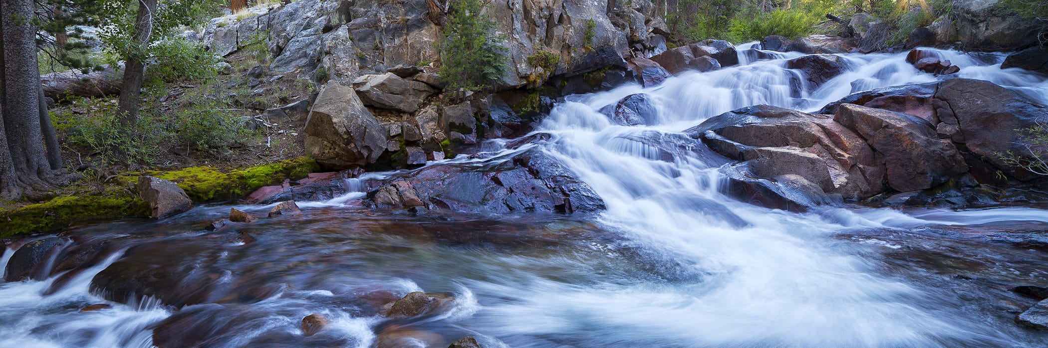 Water flows down rocky shelf surfaces.