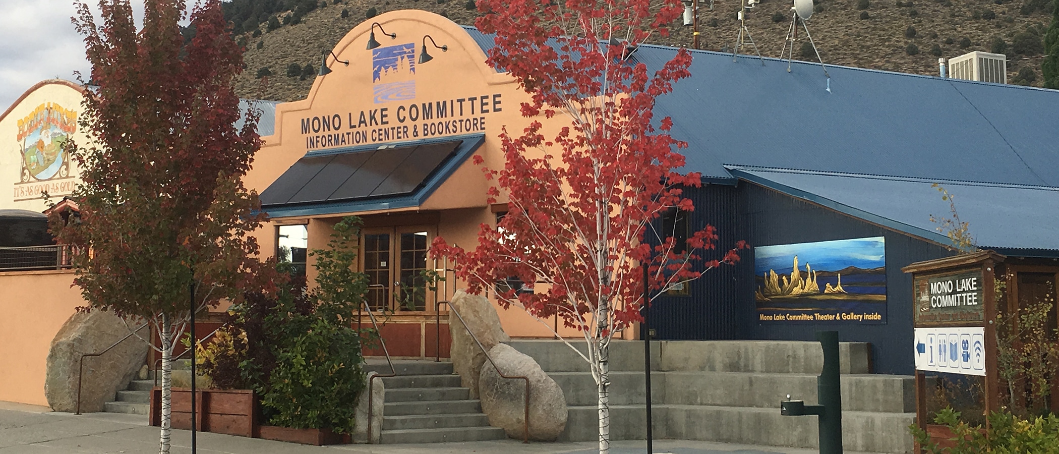 Mono Lake Committee Information Center & Bookstore storefront with trees with fall colors out front.