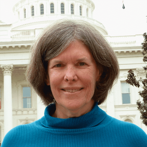 Head shot of Betsy Reifsnider in front of the Capitol in Sacramento.