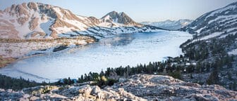 An alpine lake surrounded by granite with blue skies.