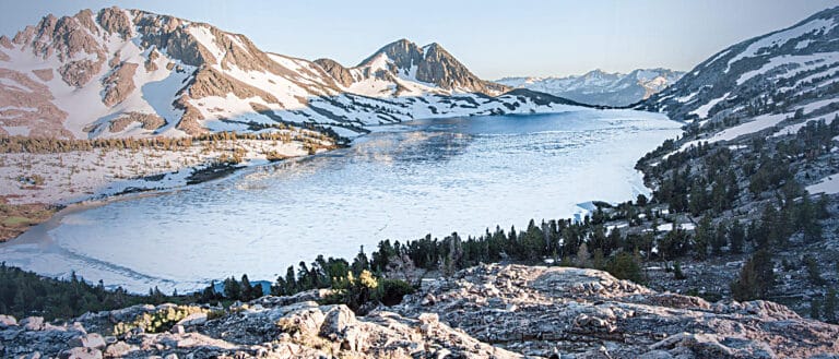 An alpine lake surrounded by granite with blue skies.