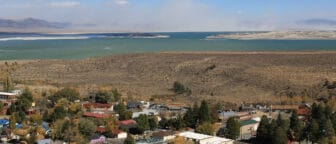 Windblown dust on the north shore of Mono Lake in the distance, the town of Lee Vining is in the foreground.