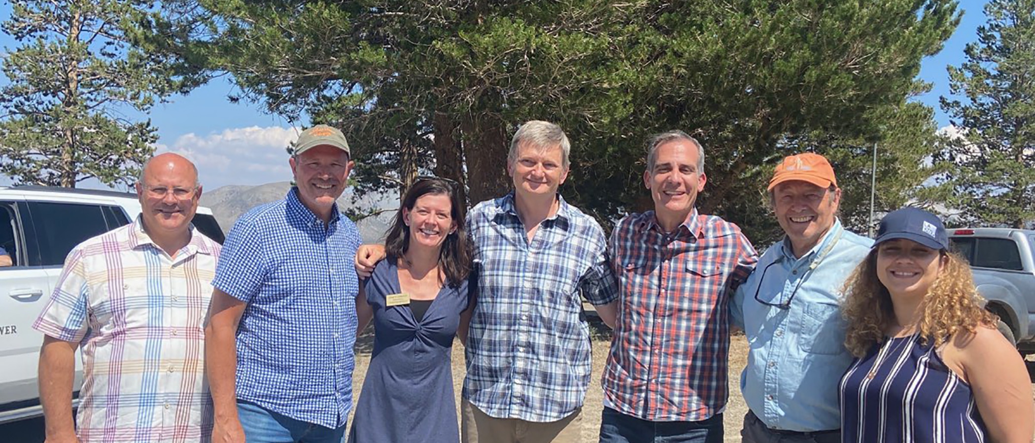 Group photo from Mayor Garcetti's visit to Rush Creek with, from left to right: LADWP General Manager & Chief Engineer Marty Adams, Title, PersonXXXX, Mono County Supervisor Stacy Corless, Mono Lake Committee Executive Director Geoff McQuilkin, LA Mayor Eric Garcetti, Mono County Supervisor Bob Gardner, and Title, PersonXXX all with smiling faces.