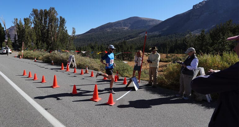 First place runner Patrick Parsel crosses the finish line.