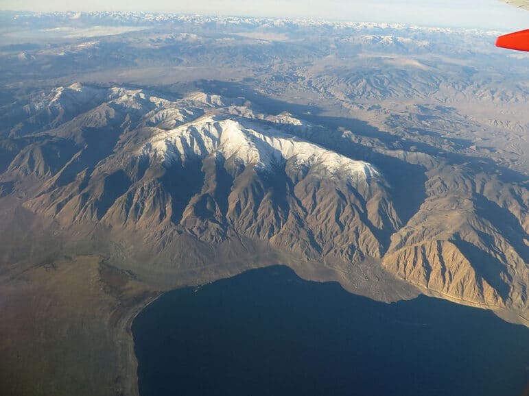 Aerial view of Walker Lake with snow dusted mountain peaks.