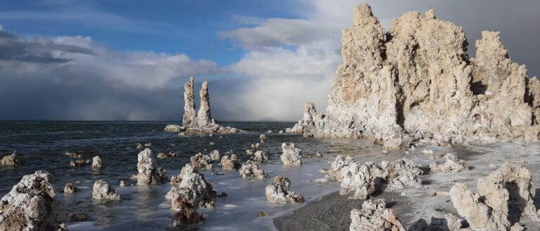 Tufa on the shore of Mono Lake with clouds in the distance.